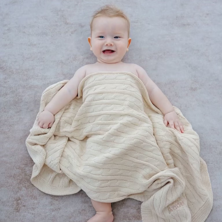 Baby covered in Personalised Cream Cable Knit Blanket