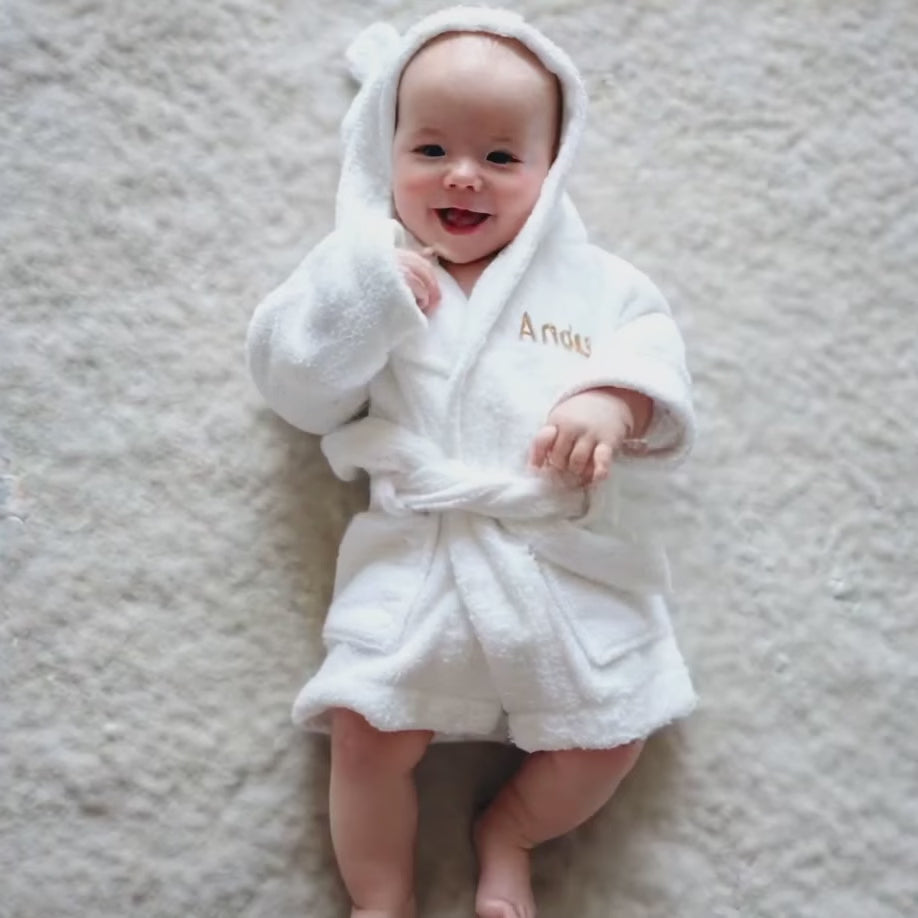 Baby wearing the personalised white bamboo robe