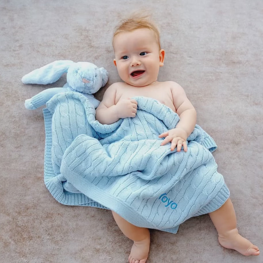 Baby covered in Personalised Blue Cable Knit Blanket