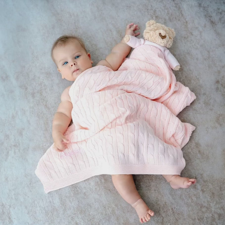 Baby covered in Personalised Pink Cable Knit Blanket