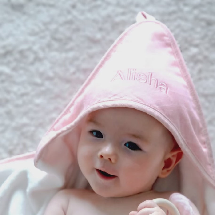 Baby using the Personalised Pink Hooded Towel 