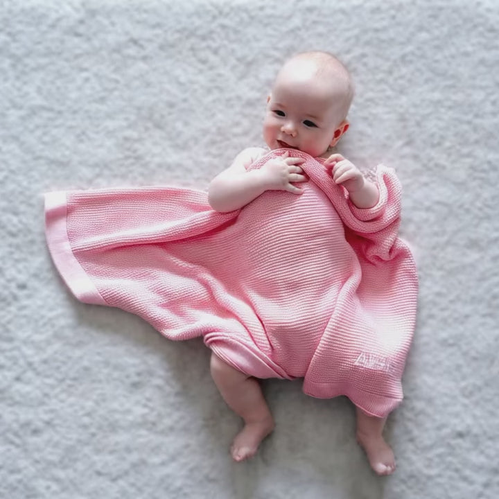 Baby covered in Personalised Pink Bamboo Cellular Blanket