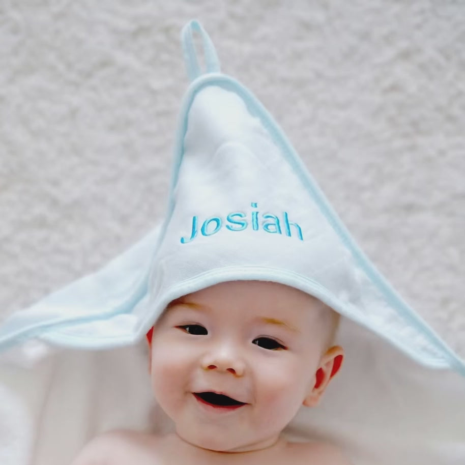 Baby using the Personalised Blue Hooded Towel 