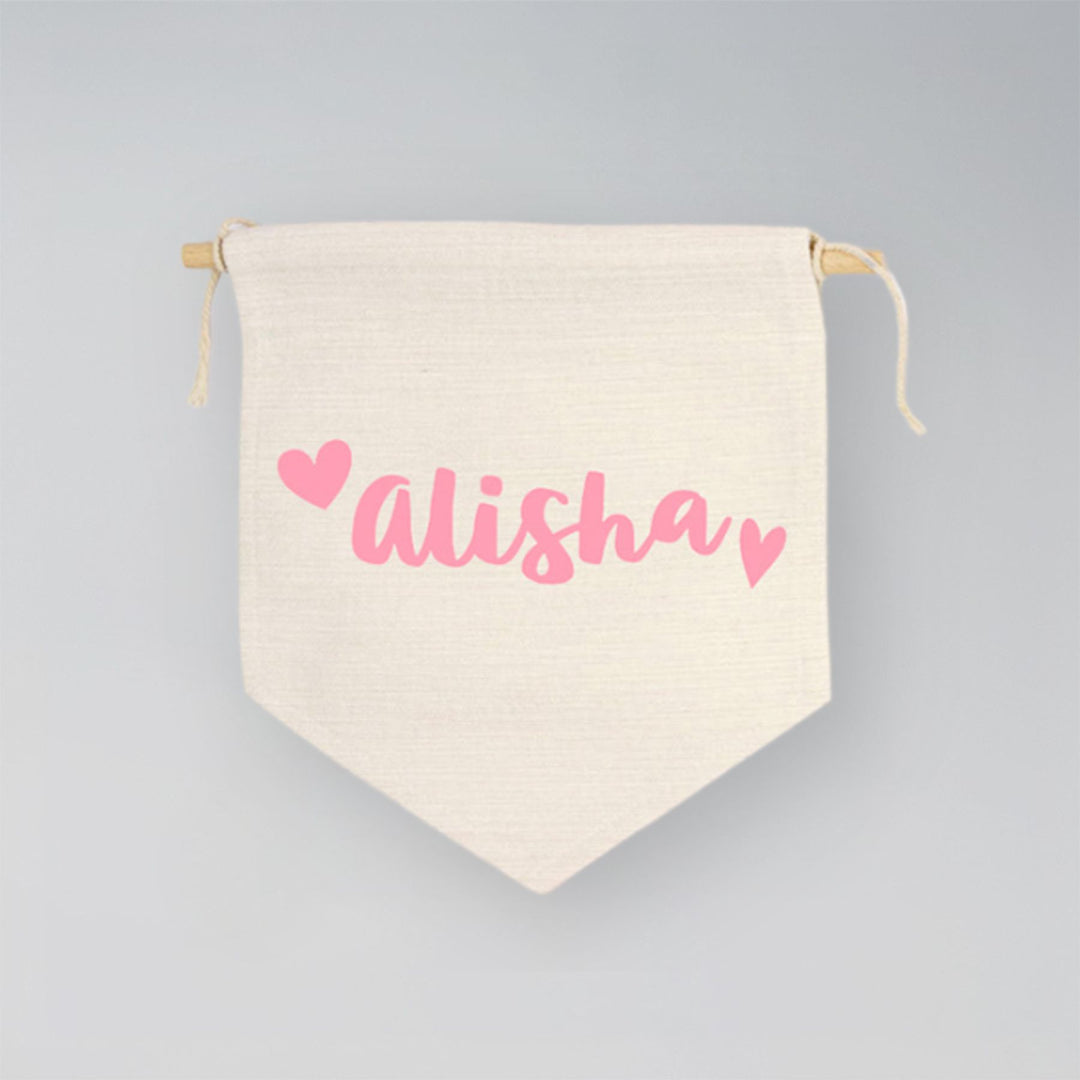 Canvas drawstring bag with 'Alisha' printed in pink on a gray background
