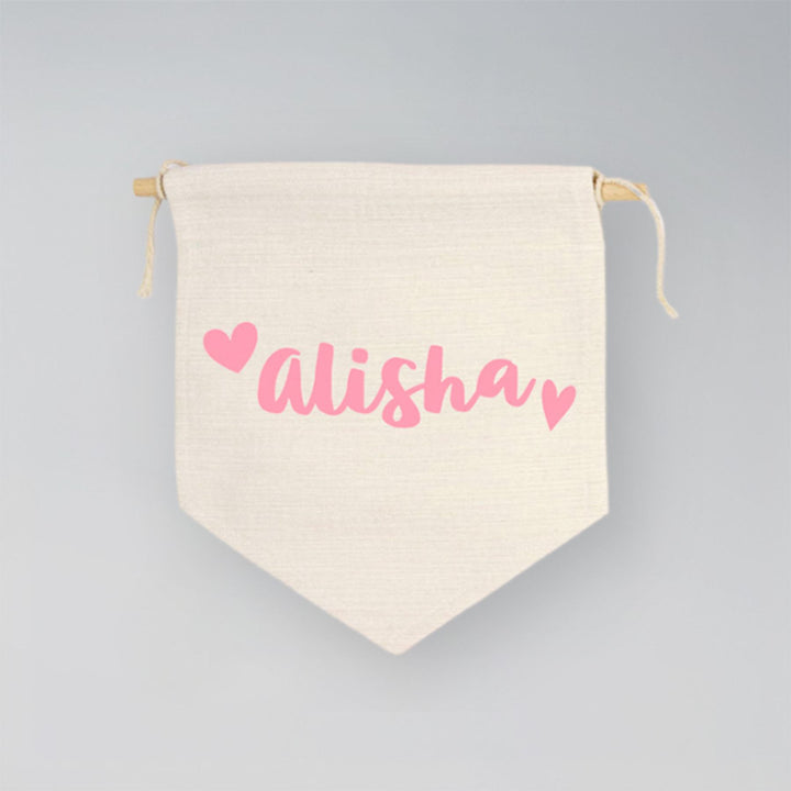 Canvas drawstring bag with 'Alisha' printed in pink on a gray background
