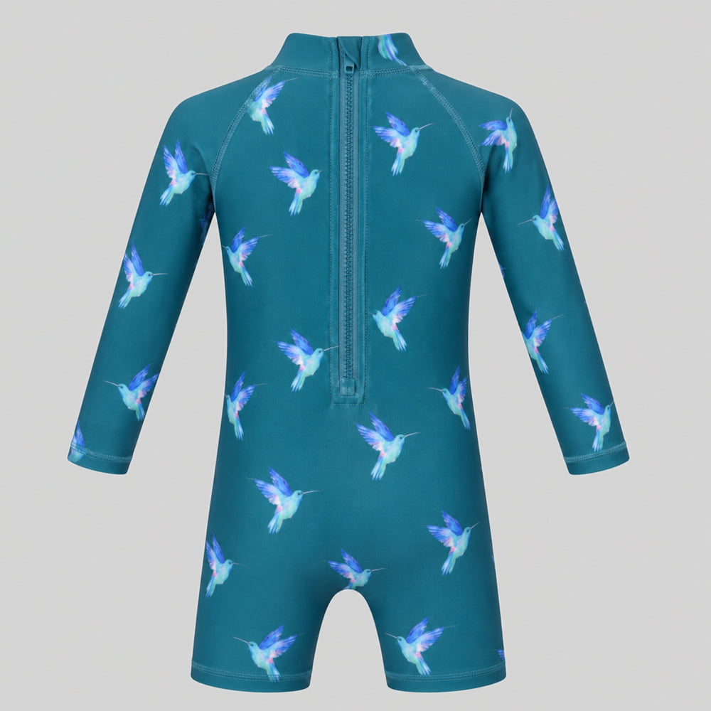 Teal hummingbird-print long-sleeve baby swimsuit with high neckline and short legs, photographed on a light grey studio background.