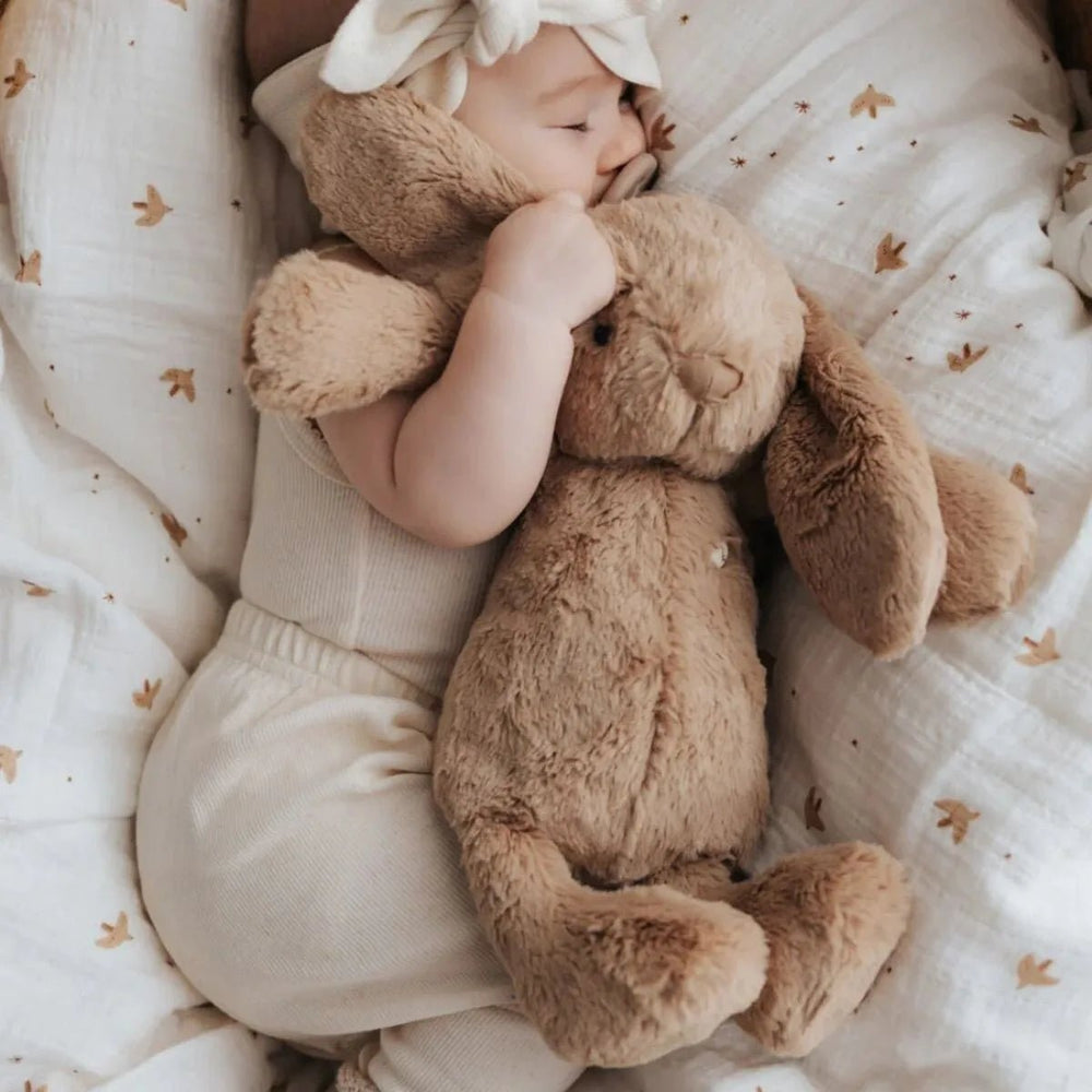 Baby hugging Snuggle Bunnies Penelope Bunny - Caramel to sleep