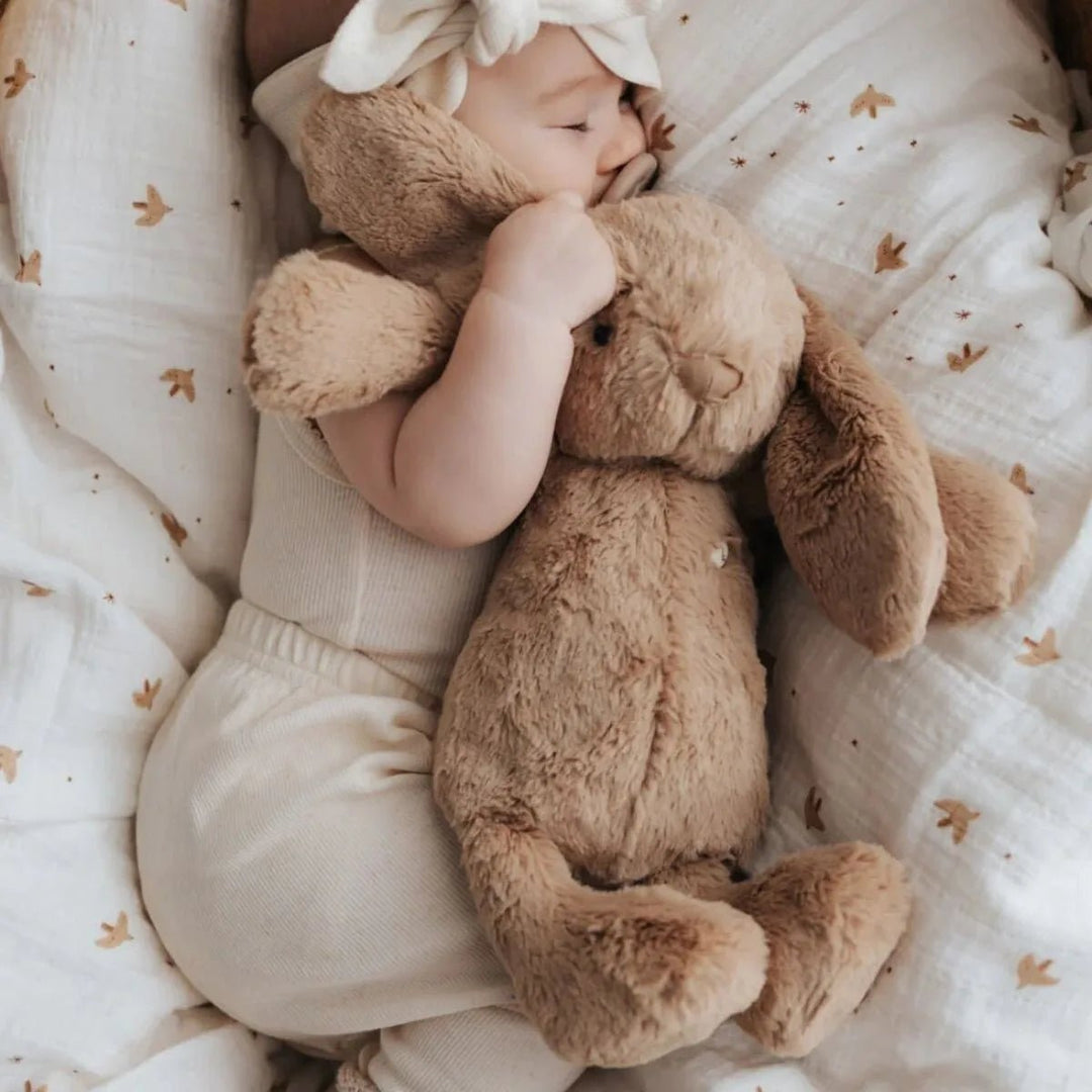 Baby hugging Snuggle Bunnies Penelope Bunny - Caramel to sleep