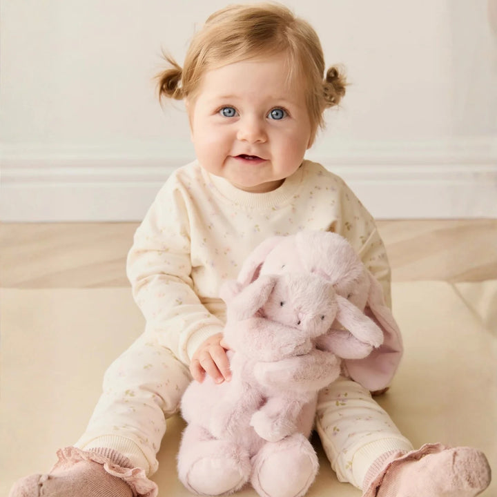 Baby holding her Snuggle Bunnies Frankie the Hugging Bunny - Blossom