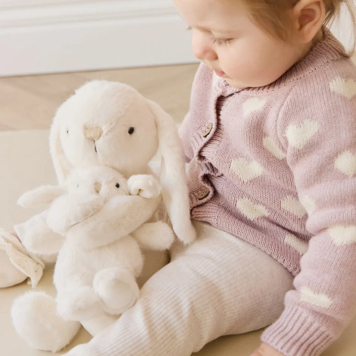 Baby playing with Snuggle Bunnies Frankie the Hugging Bunny - Marshmallow