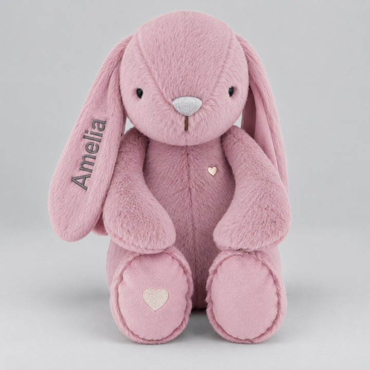  Pink Snuggle Bunnies plush bunny with "Amelia" embroidered in grey thread on its floppy ear.