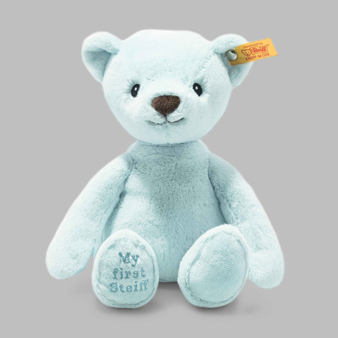 Close-up of Steiff Teddy Bear with signature ear tag – soft blue plush toy for babies