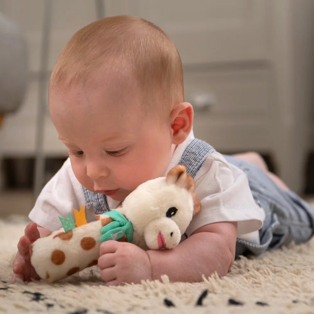 Baby Playing with Sophie la girafe Pouet Rattle Soft Toy During Tummy Time
