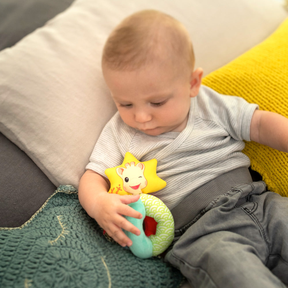 Baby playing with Sophiesticated Rattle 
