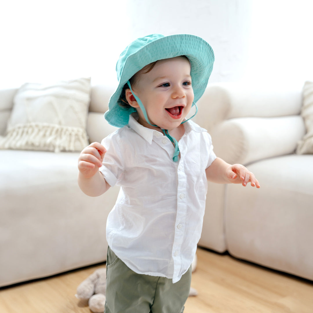 Toddler wearing green summer hat 