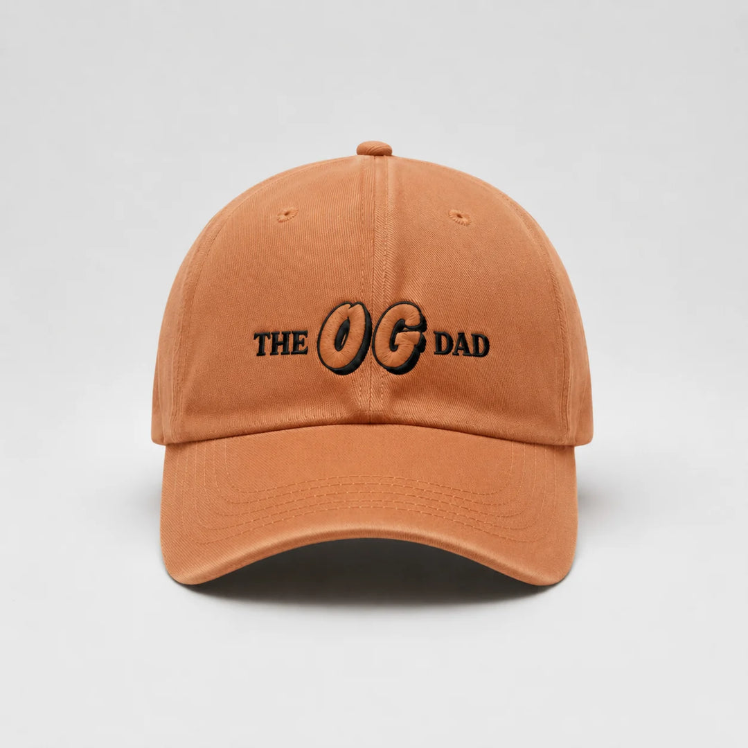 Orange cap with 'THE OG DAD' text on a light gray background