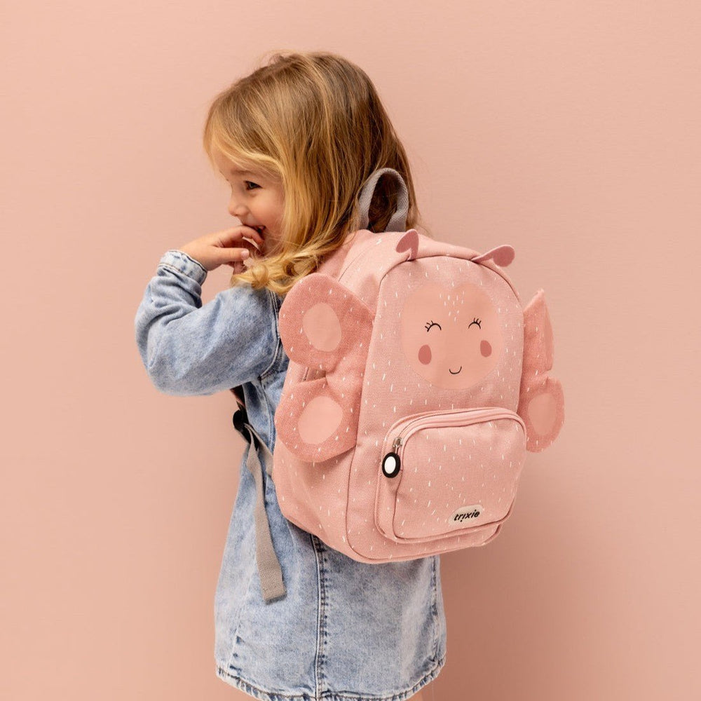 Happy girl carrying her Trixie Mrs. Butterfly Backpack