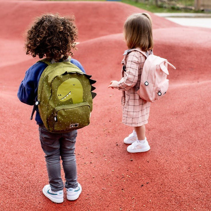 Boy carrying Trixie Dino backpack and Girl carrying Trixie Bunny Backpack