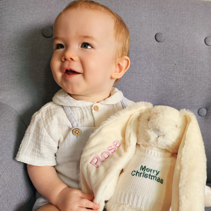 Baby holding a personalied Christmas Twinkle Bunny