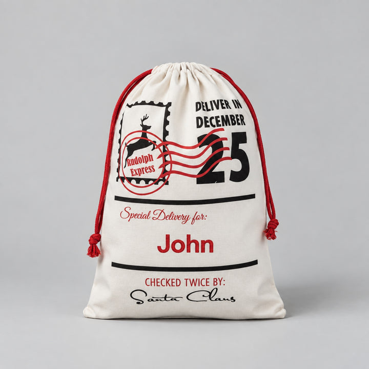 Cream Christmas drawstring sack featuring a Rudolph Express postage design, “Deliver in December 25”, Santa Claus signature and the name “John” personalised in red.