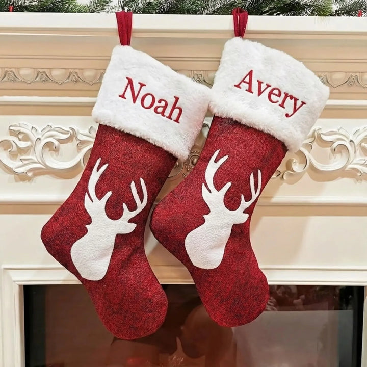Two red Christmas stockings with white fur trim and reindeer designs, personalized with 'Noah' and 'Avery', hanging on a decorative fireplace mantle.