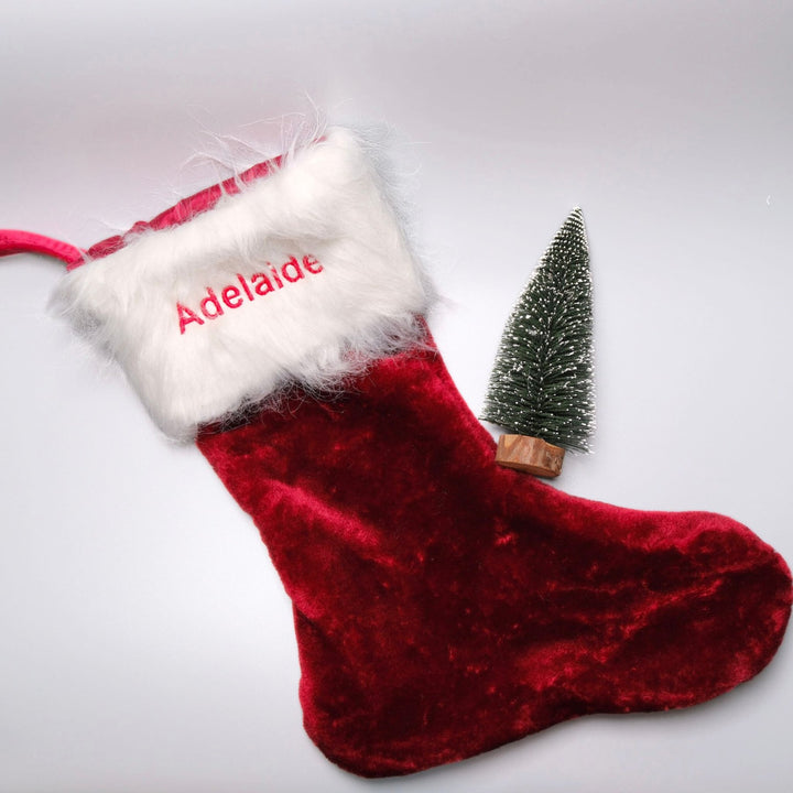 Red velvet christmas stocking personalised with "Adelaide" in red thread